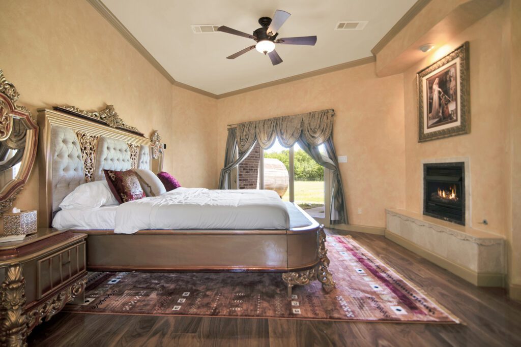 Luxury bedroom suite with fireplace at Castle Waterford near Dallas