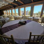 Indoor banquet setup with round tables and window view at Castle Waterford event space