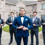 Groom with groomsmen in formal suits posing at Castle Waterford wedding venue
