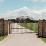 Main entrance gate of Castle Waterford with long driveway and open landscape view