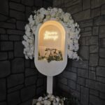 Wedding welcome sign with floral décor and soft lighting at Castle Waterford entrance