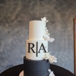 Elegant tiered wedding cake with minimalist design and initials at Castle Waterford