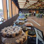 Wedding dessert table with cupcakes and sweets arranged in reception hall at Castle Waterford