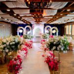 Indoor wedding aisle with floral decorations and elegant seating setup at Castle Waterford