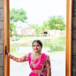 Woman in traditional Indian attire standing by window with scenic outdoor view at Castle Waterford