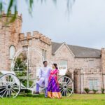 Couple in traditional Indian attire posing with vintage carriage at Castle Waterford outdoor setting