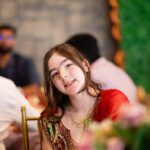 Woman in traditional attire smiling during wedding celebration at Castle Waterford indoor setting