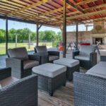 Outdoor lounge seating area with sofa set and wooden pergola at Castle Waterford venue