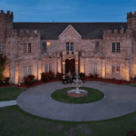 Castle Waterford courtyard with fountain illuminated at dusk showcasing grand entrance