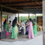 Women dancing together during pre-wedding celebration at Castle Waterford outdoor setup