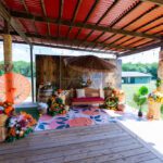 Colorful haldi ceremony setup with floral décor and seating at Castle Waterford outdoor space