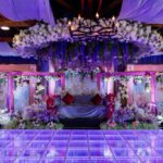 Luxury wedding stage with LED dance floor, floral décor, and ambient lighting at Castle Waterford