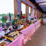 Wedding dessert and food display table with floral décor at Castle Waterford reception