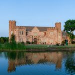 Castle Waterford reflected in lake during daytime showcasing scenic architecture and surroundings