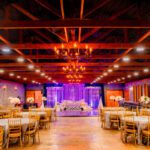 Luxury indoor wedding reception hall with stage, lighting, and banquet seating at Castle Waterford