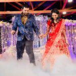Couple dancing at wedding reception with fog effect and colorful stage lighting at Castle Waterford