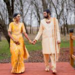 Couple in traditional Indian attire holding hands during outdoor wedding photoshoot at Castle Waterford