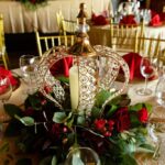 Elegant wedding table centerpiece with decorative lantern, candles, and floral arrangement at Castle Waterford