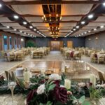 Indoor banquet hall setup with floral décor and seating arrangement at Castle Waterford