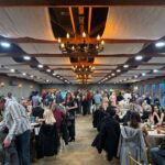 Large wedding reception with guests seated and dining in banquet hall at Castle Waterford