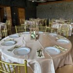 Elegant round dining table setup with plates, cutlery, and gold chairs at Castle Waterford reception