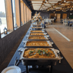 Wedding buffet with multiple hot dishes in chafing trays at Castle Waterford reception hall