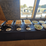 Wedding buffet table with snacks, pastries, and salad dishes at Castle Waterford event