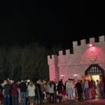 Guests gathered outside Castle Waterford entrance at night during wedding celebration