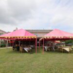 Outdoor event setup with pink canopy tents and seating arrangement at Castle Waterford lawn