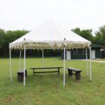 Outdoor event tent setup with seating arrangement at Castle Waterford lawn area