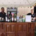 Wedding bar setup with drinks and bartenders serving guests at Castle Waterford