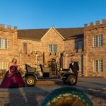Vintage car arrival at Castle Waterford with elegantly dressed guests in front of historic castle venue