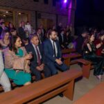 Guests seated on benches during indoor wedding ceremony at Castle Waterford
