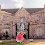 Couple in traditional Indian attire posing in front of Castle Waterford building