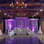 Luxury wedding stage with purple lighting, LED dance floor, and floral backdrop at Castle Waterford
