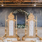Ornate golden royal chairs setup with floral arch at Castle Waterford wedding ceremony