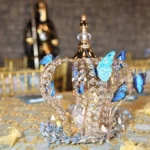 Elegant crown centerpiece with decorative butterflies on wedding table at Castle Waterford