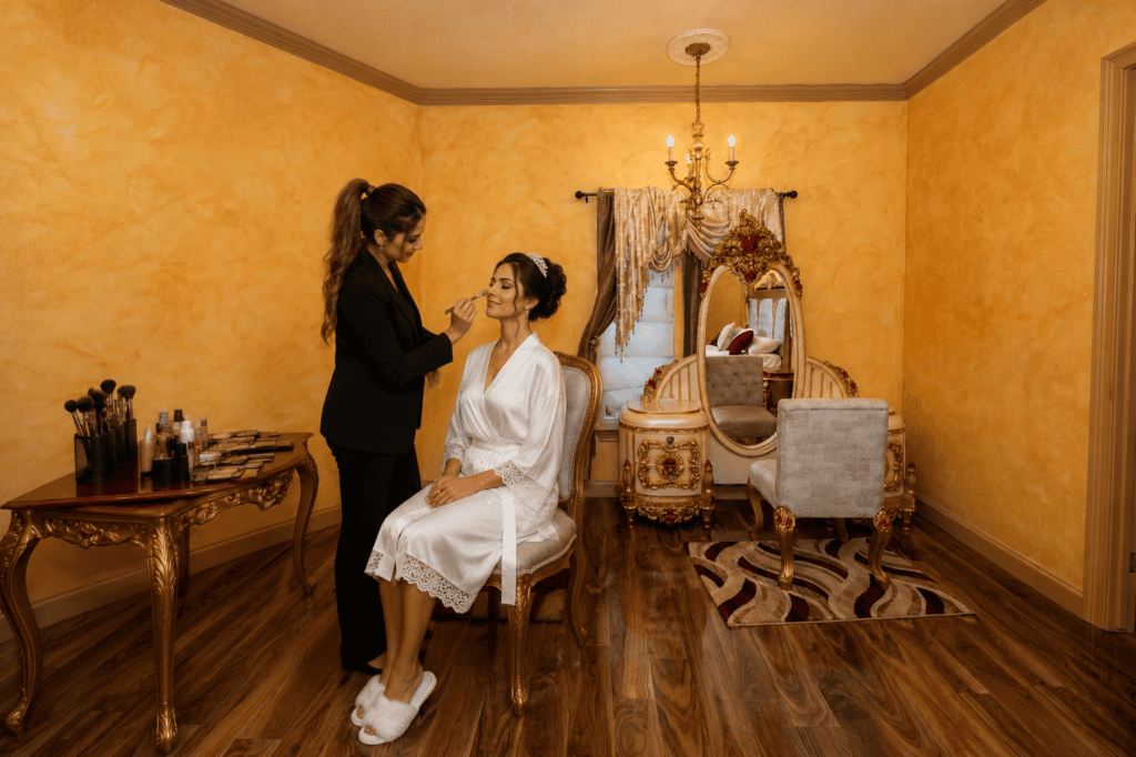 Bride having professional wedding makeup done in a private bridal suite